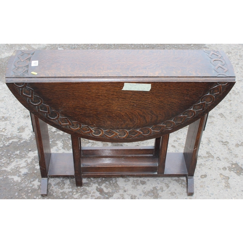 161 - An antique style oak drop leaf table with carved details, approx 90cm wide x 92cm deep x 71cm tall w... 