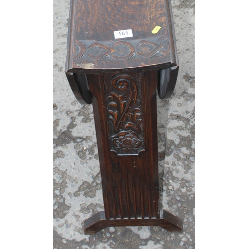 161 - An antique style oak drop leaf table with carved details, approx 90cm wide x 92cm deep x 71cm tall w... 