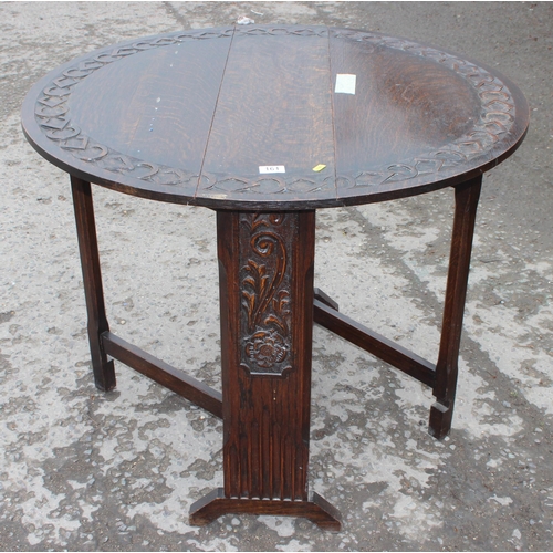 161 - An antique style oak drop leaf table with carved details, approx 90cm wide x 92cm deep x 71cm tall w... 