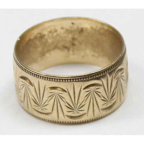 1108 - A retro 9ct gold band ring with wavy engraved design and beaded edge, marked and XRF confirmed, appr... 