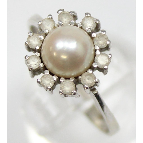 1153 - A vintage 18ct white gold, diamond and pearl cocktail ring, a large central pearl surrounded by 10 s... 