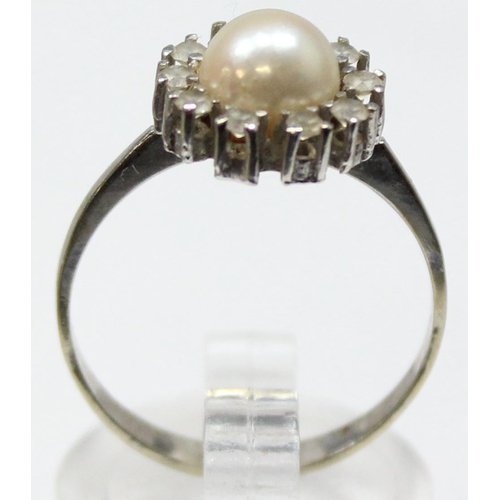 1153 - A vintage 18ct white gold, diamond and pearl cocktail ring, a large central pearl surrounded by 10 s... 