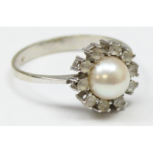 1153 - A vintage 18ct white gold, diamond and pearl cocktail ring, a large central pearl surrounded by 10 s... 