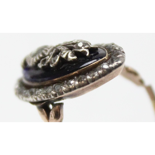 1189 - A Georgian diamond and blue enamel navette ring, a border of small diamonds surround the blue enamel... 