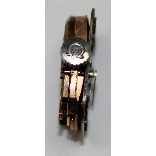 1321 - An Omega 485 cal mechanical watch movement with metallic blue face and baton numerals, approx 16mm x... 