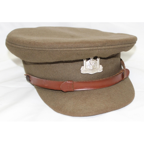 1403 - A vintage military officer's cap with Cambridgeshire Regiment badge, a WW2 or earlier period leather... 