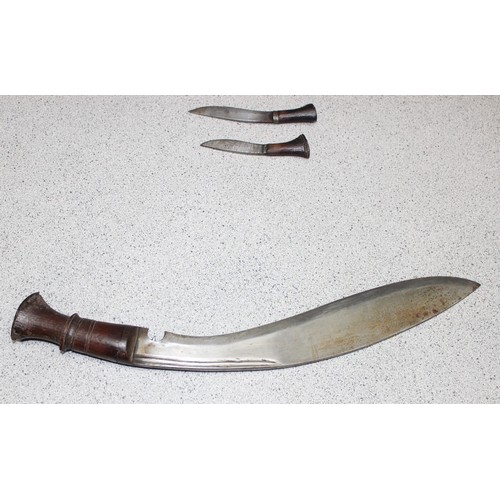 1410 - Vintage Kukri knife in wooden scabbard with two incorporated sharpening knives, and a pair of touris... 