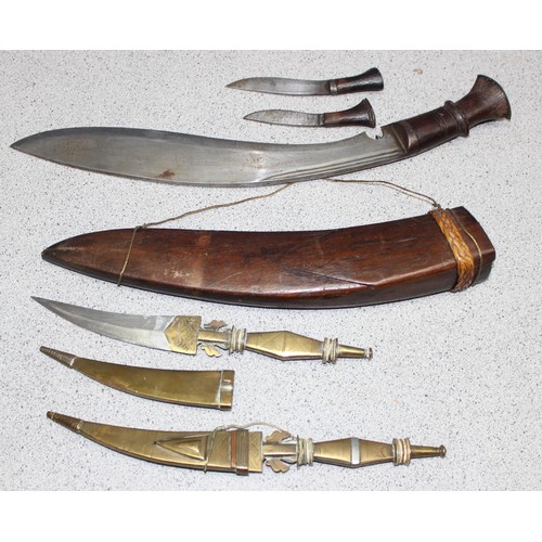 1410 - Vintage Kukri knife in wooden scabbard with two incorporated sharpening knives, and a pair of touris... 