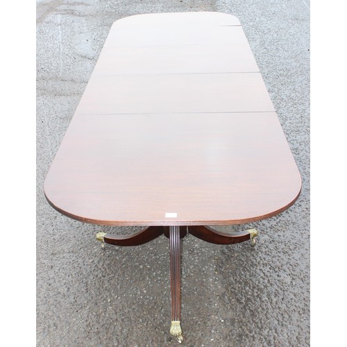 44 - A large antique style mahogany pedestal dining table, approx 212cm wide (310cm fully extended) x 100... 