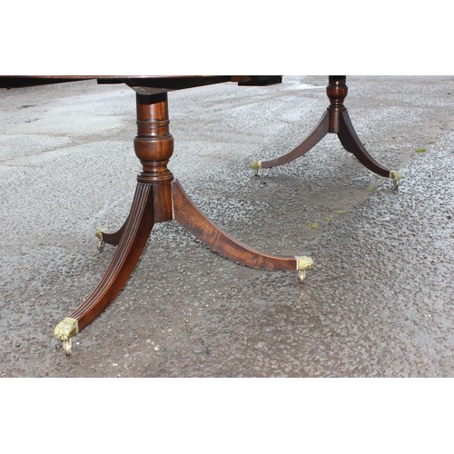 44 - A large antique style mahogany pedestal dining table, approx 212cm wide (310cm fully extended) x 100... 