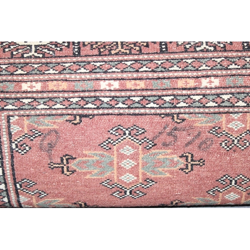 200 - A vintage Bokhara style rug of salmon ground, approx 180cm x 131cm