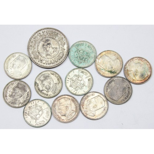 1206 - A 1956 silver Moroccan 500 Franc coin and 11 silver 1 Diram coins, approx 88.34g gross