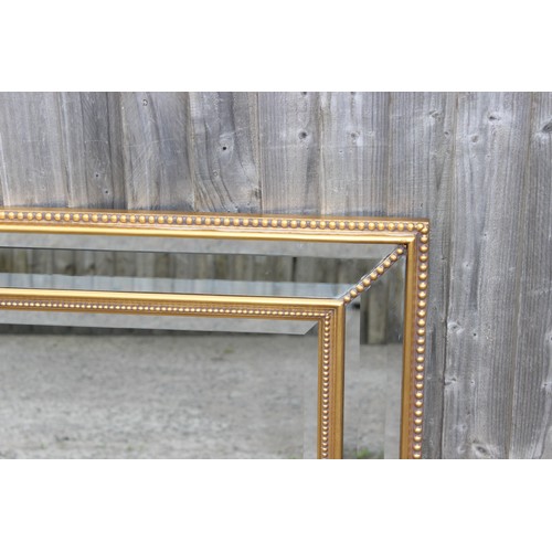 490 - A modern gilt and stepped glass framed mirror, approx 103cm x 79cm