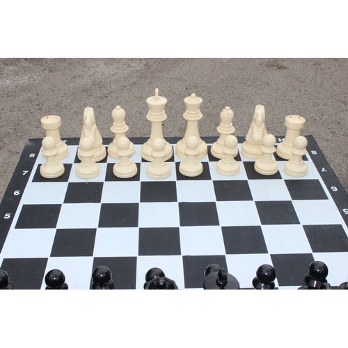 1522 - Garden chess set in wicker basket, chess board with table base approx 90cm wide x 90cm deep x 74cm t... 