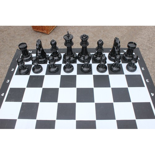 1522 - Garden chess set in wicker basket, chess board with table base approx 90cm wide x 90cm deep x 74cm t... 