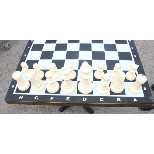 1522 - Garden chess set in wicker basket, chess board with table base approx 90cm wide x 90cm deep x 74cm t... 