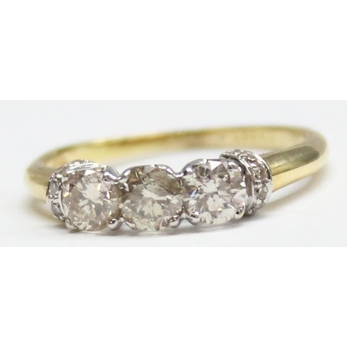 1110B - A vintage 18ct gold trilogy diamond ring, set with 3 larger diamonds and smaller diamond shoulder mo... 