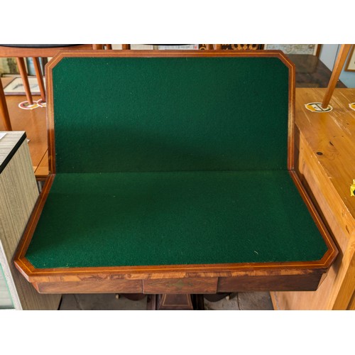 170 - An antique mahogany card table with fold over top, baize lined interior and  games, approx 90cm wide... 