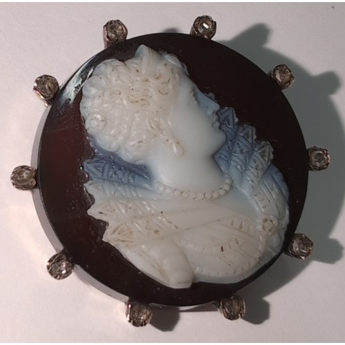 1164 - An 18ct gold and diamond set cameo brooch carved with and Elizabethan female bust, indistinctly mark... 