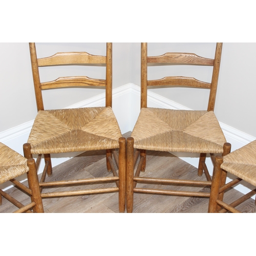 72 - A set of 4 Arts & Crafts period light oak and rush seated dining chairs