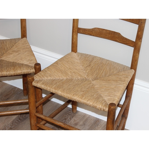 72 - A set of 4 Arts & Crafts period light oak and rush seated dining chairs