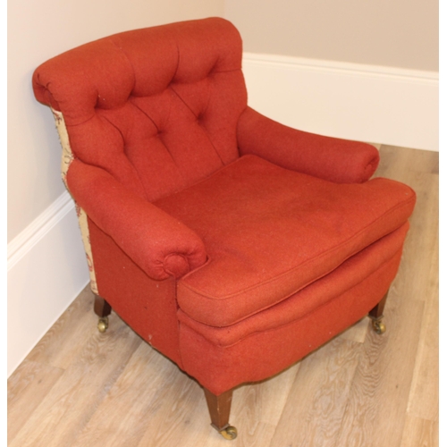 61 - A Victorian button backed low armchair with red upholstery, square tapered mahogany legs and brass c... 