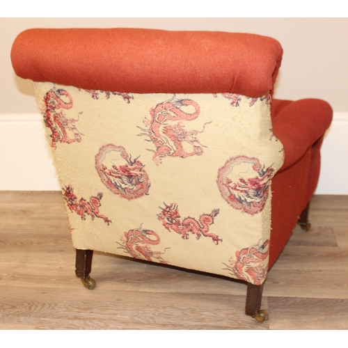 61 - A Victorian button backed low armchair with red upholstery, square tapered mahogany legs and brass c... 