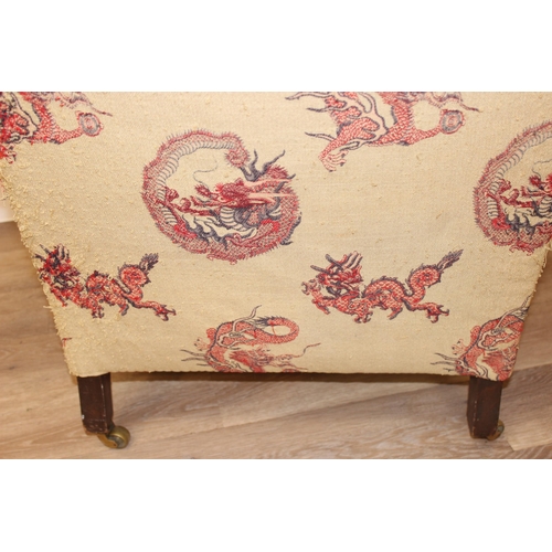 61 - A Victorian button backed low armchair with red upholstery, square tapered mahogany legs and brass c... 