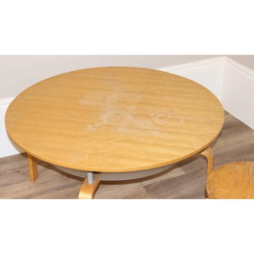 78 - A Scandinavian style round low table with glass undertier, and a pair of similar lightwood stools wi... 