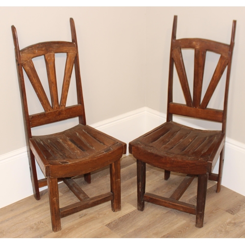 59 - A pair of unusual vintage high back chairs made from wooden cart wheel parts, each approx 115cm tall