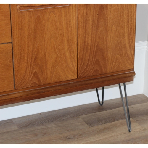 36 - A retro wooden sideboard on hairpin legs, seemingly unmarked but possibly Meredew, 2 drawers to cent... 