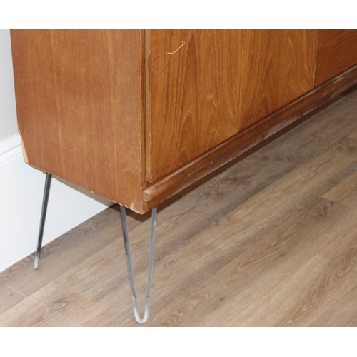 36 - A retro wooden sideboard on hairpin legs, seemingly unmarked but possibly Meredew, 2 drawers to cent... 