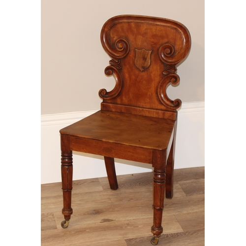 67 - An antique mahogany hall chair with decorative carved back, approx 46cm wide x 46cm deep x 85cm tall