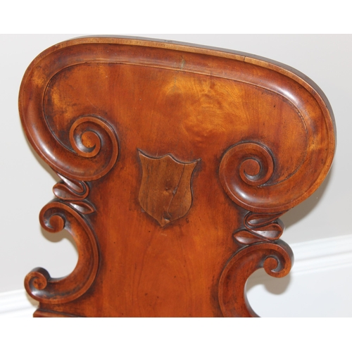 67 - An antique mahogany hall chair with decorative carved back, approx 46cm wide x 46cm deep x 85cm tall