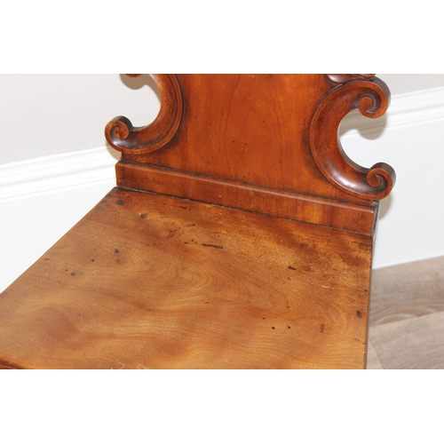 67 - An antique mahogany hall chair with decorative carved back, approx 46cm wide x 46cm deep x 85cm tall