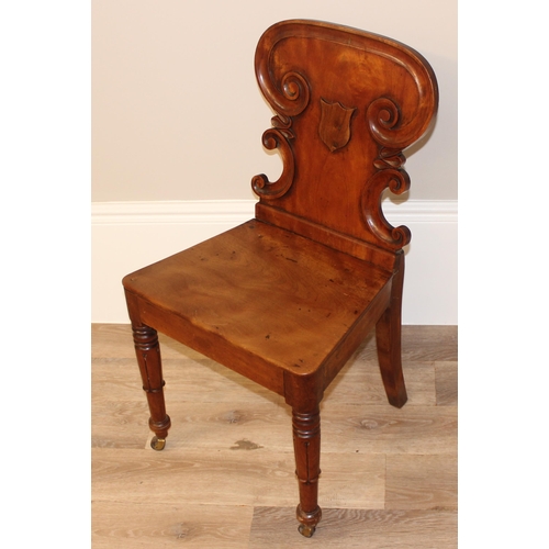 67 - An antique mahogany hall chair with decorative carved back, approx 46cm wide x 46cm deep x 85cm tall