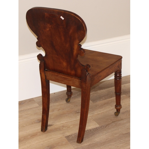 67 - An antique mahogany hall chair with decorative carved back, approx 46cm wide x 46cm deep x 85cm tall