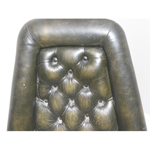 65 - A vintage green leather Chesterfield button backed desk chair with wooden base, approx 61cm wide x 6... 