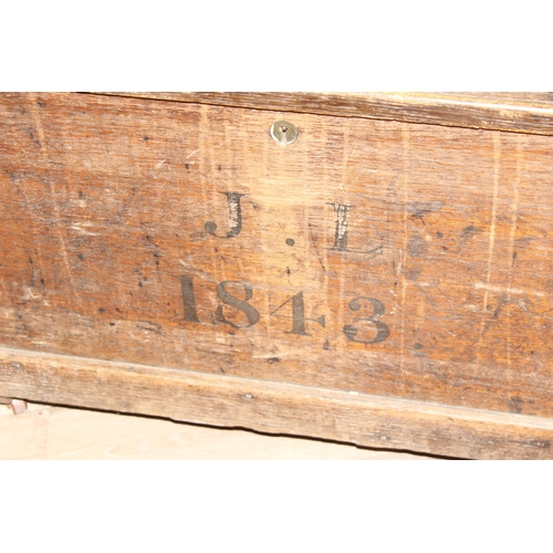 43 - A 19th century wooden trunk with painted decoration, dated 1843 with initials JL, on later wheels, a... 