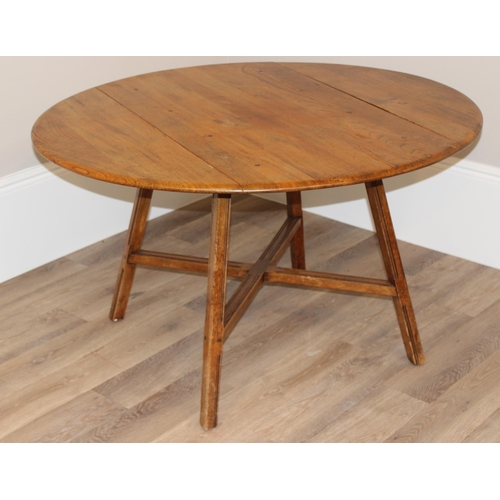 30 - A retro Ercol drop leaf dining table, oval topped, approx 60cm wide (124cm extended) x 113cm deep x ... 