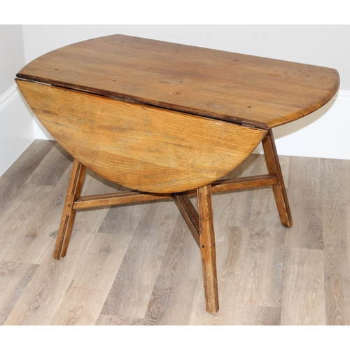 30 - A retro Ercol drop leaf dining table, oval topped, approx 60cm wide (124cm extended) x 113cm deep x ... 