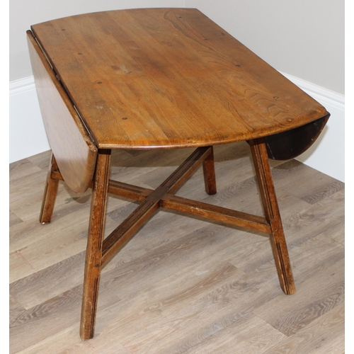 30 - A retro Ercol drop leaf dining table, oval topped, approx 60cm wide (124cm extended) x 113cm deep x ... 