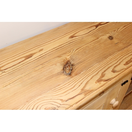 4 - An antique stripped pine 2 door sideboard or cabinet, approx 152cm wide x 49cm deep x 100cm tall