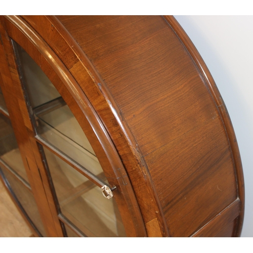 17 - An unusual Art Deco period circular display cabinet with glass shelves, approx 117cm wide x 31cm dee... 