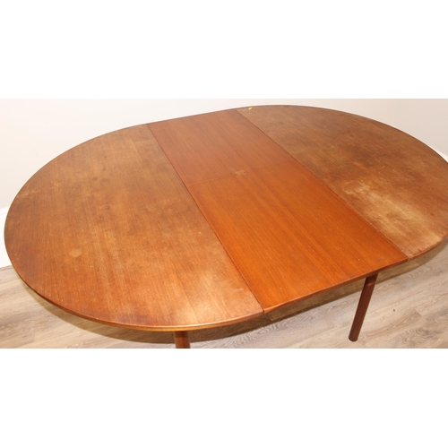 27 - A.H. McIntosh & Co of Kirkcaldy, a retro extendable circular dining table, approx 122cm wide (168cm ... 