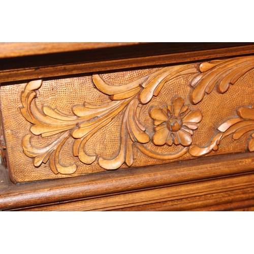 96 - A highly impressive carved wooden double bed, likely early 20th century, consisting of head and foot... 