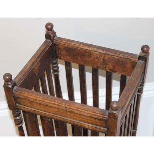 11 - A vintage oak stick stand with slatted uprights, approx 30cm wide x 26cm deep x 67cm tall