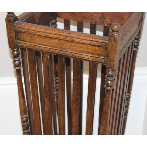 11 - A vintage oak stick stand with slatted uprights, approx 30cm wide x 26cm deep x 67cm tall