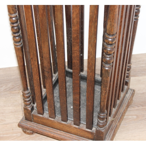 11 - A vintage oak stick stand with slatted uprights, approx 30cm wide x 26cm deep x 67cm tall