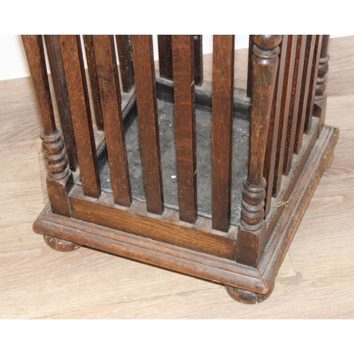 11 - A vintage oak stick stand with slatted uprights, approx 30cm wide x 26cm deep x 67cm tall